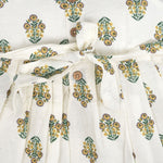 Toddler girl wearing an ivory sleeveless cotton frock with traditional floral butta print – ethnic babywear from Boon Babies, Coimbatore.