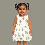 Toddler girl wearing an ivory sleeveless cotton frock with traditional floral butta print – ethnic babywear from Boon Babies, Coimbatore.