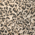 Leopard print sleeveless cotton frock for girls aged 12M–5Y, with a flared pleated skirt – displayed on a wooden hanger with white roses in the background.