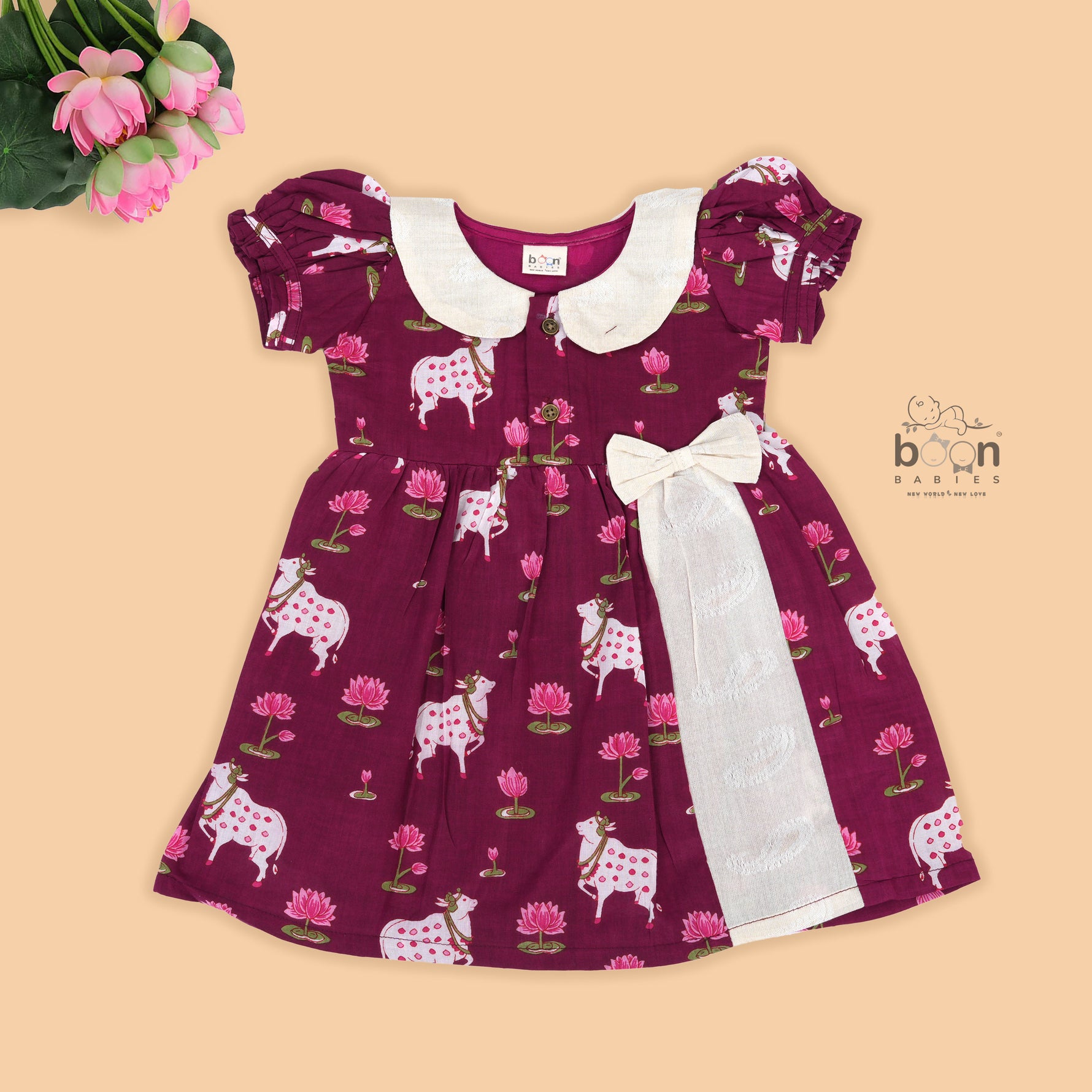 Maroon cotton puff frock with front collar, bow tie & lotus print. Stylish & comfy for girls aged 6M–4Y.