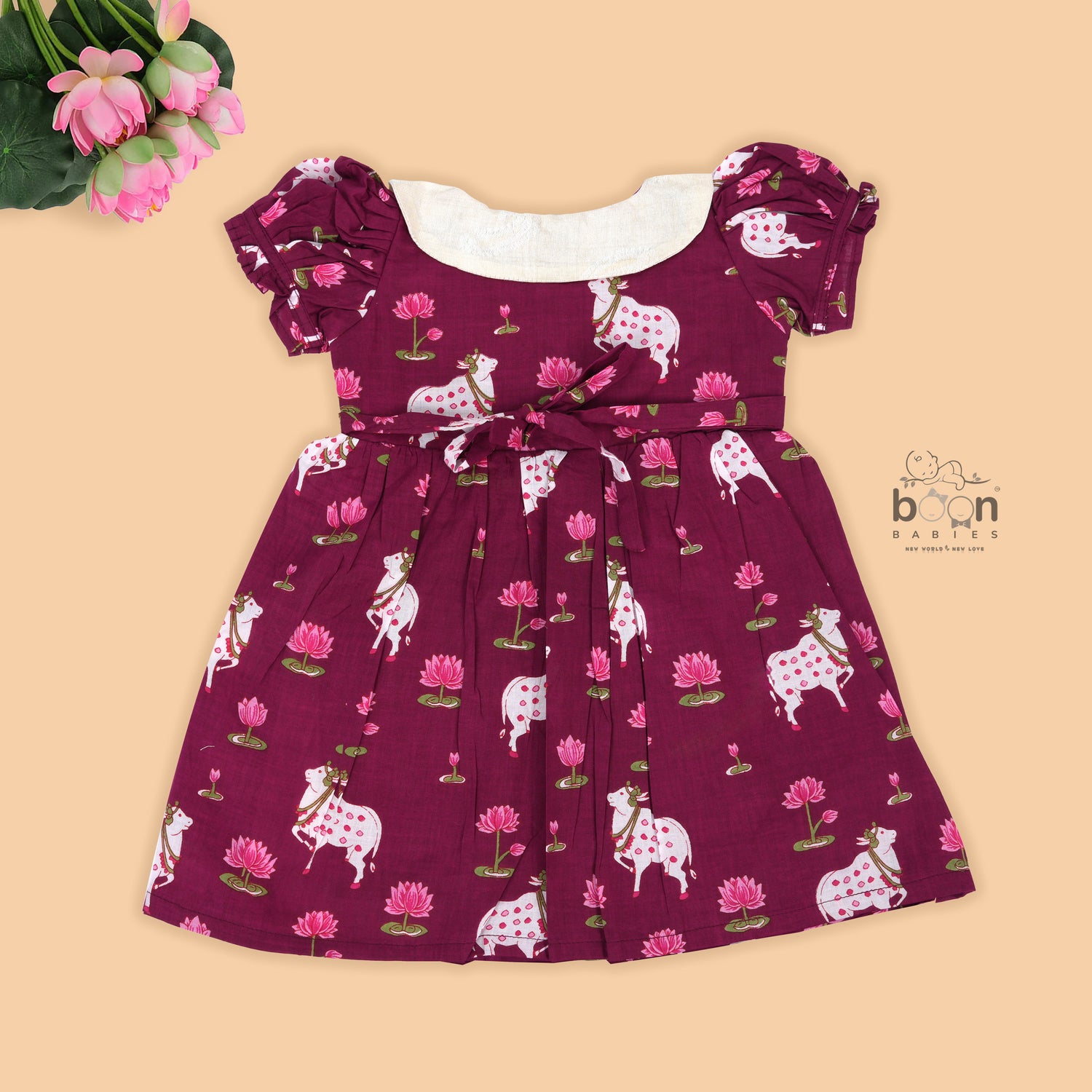 Maroon cotton puff frock with front collar, bow tie & lotus print. Stylish & comfy for girls aged 6M–4Y.
