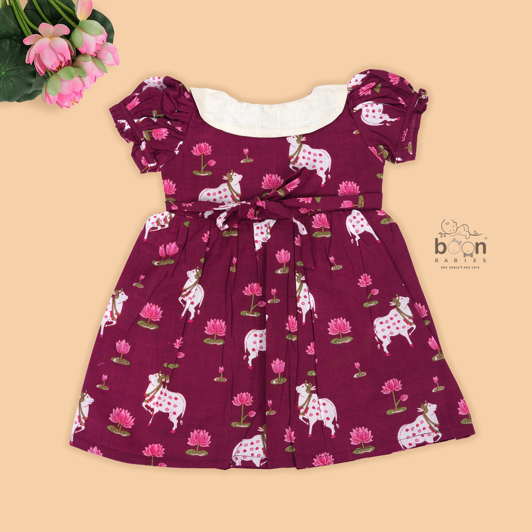 Maroon cotton puff frock with front collar, bow tie & lotus print. Stylish & comfy for girls aged 6M–4Y.