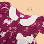 Maroon cotton puff frock with front collar, bow tie & lotus print. Stylish & comfy for girls aged 6M–4Y.