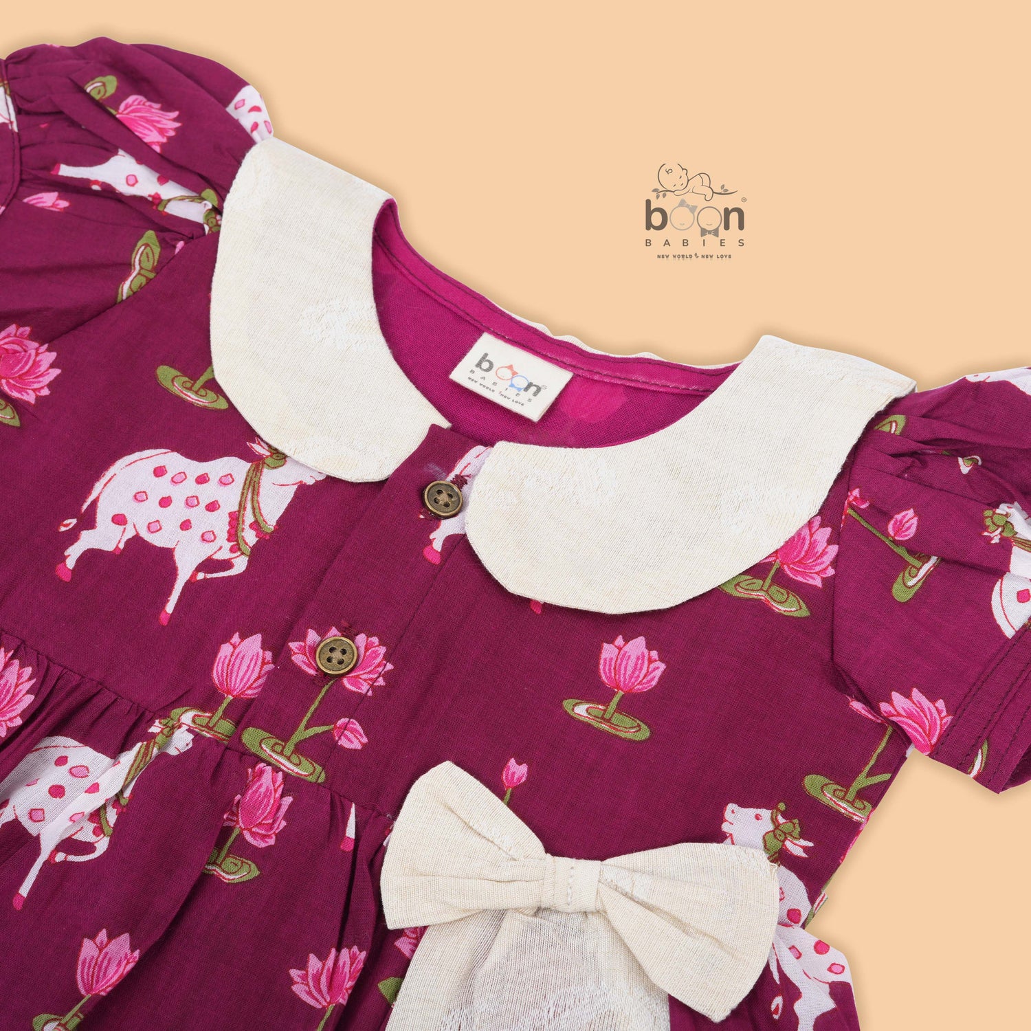 Maroon cotton puff frock with front collar, bow tie & lotus print. Stylish & comfy for girls aged 6M–4Y.