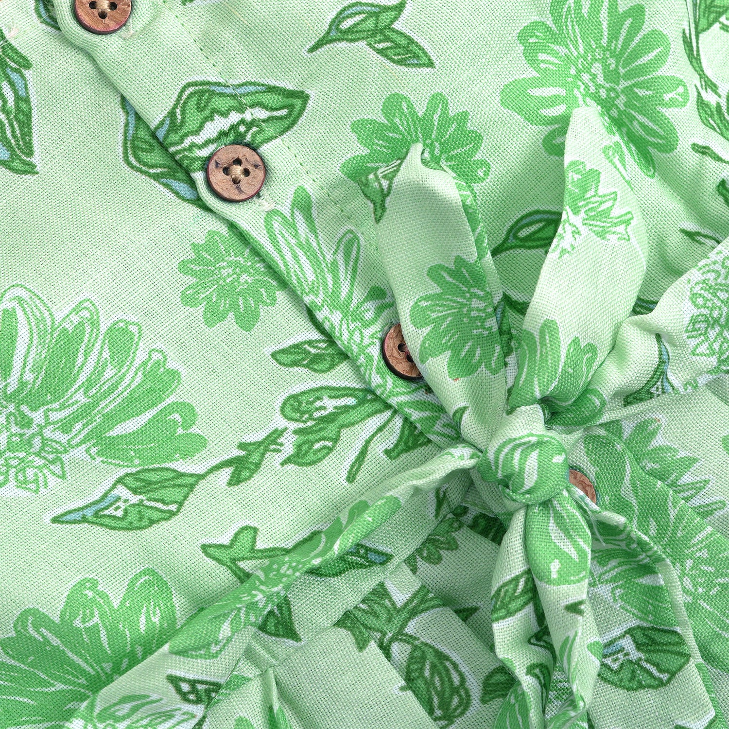 Mint green floral printed sleeveless slub cotton frock for baby girls with pleated flare, displayed flat on white fur background with floral basket hanger.