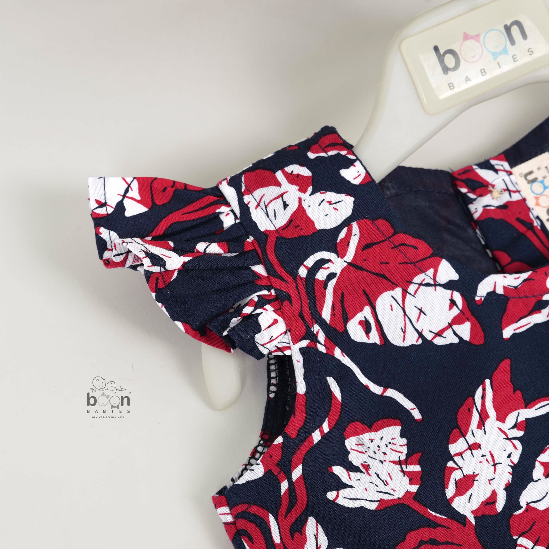 Bold navy cotton frock with red & white florals. Made for 6M–5Y girls. Twirl-ready, comfy, and cute!
