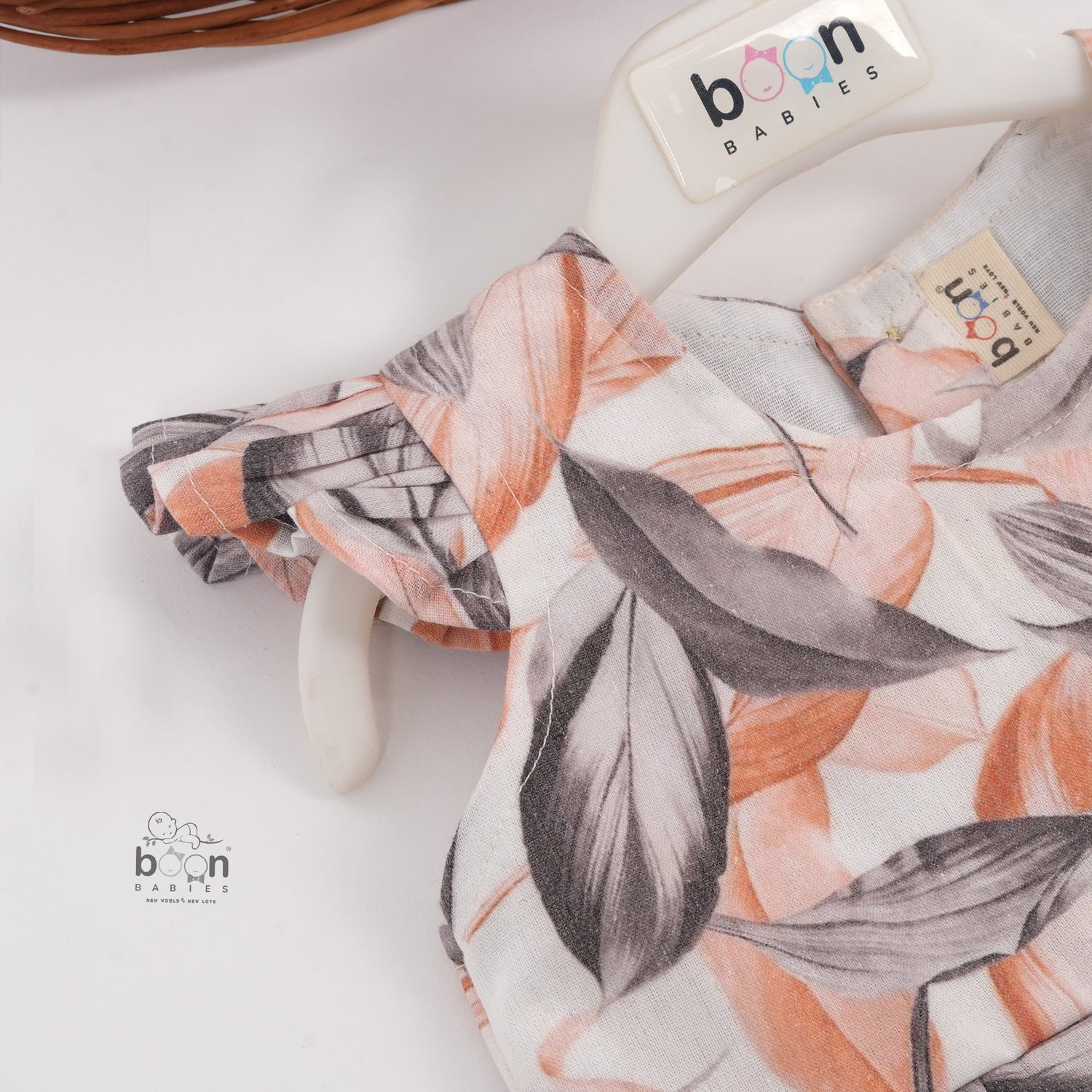 Elegant cotton frock with peach & grey leaf print and cap sleeves. Ideal for girls aged 6M to 5Y.