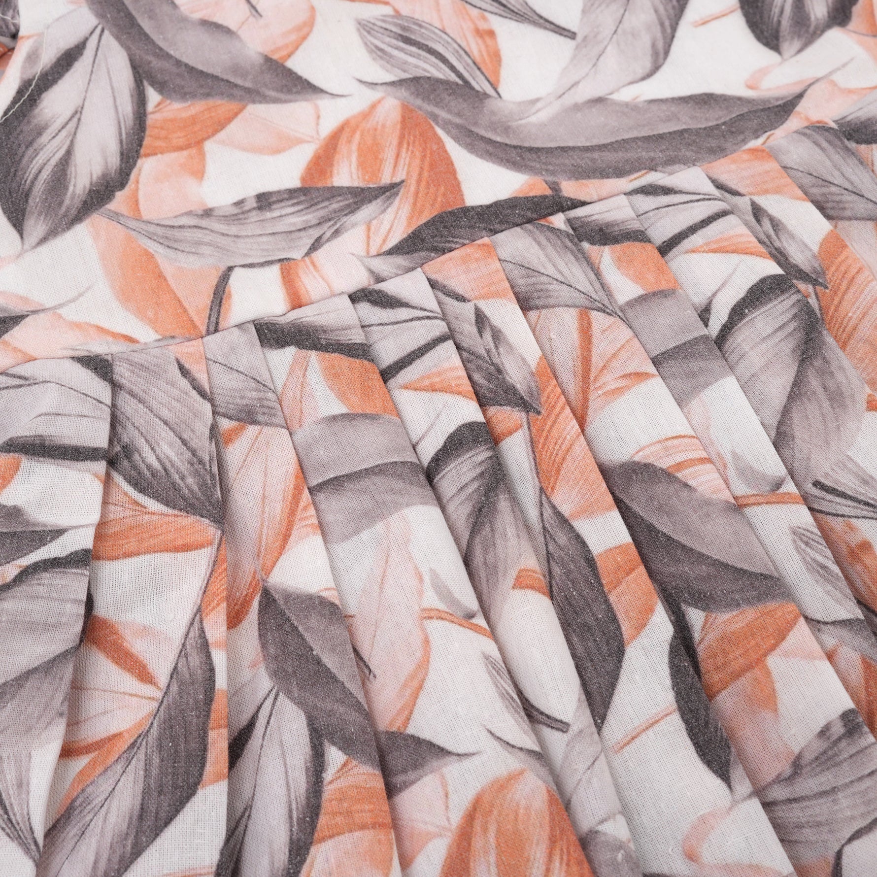 Elegant cotton frock with peach & grey leaf print and cap sleeves. Ideal for girls aged 6M to 5Y.