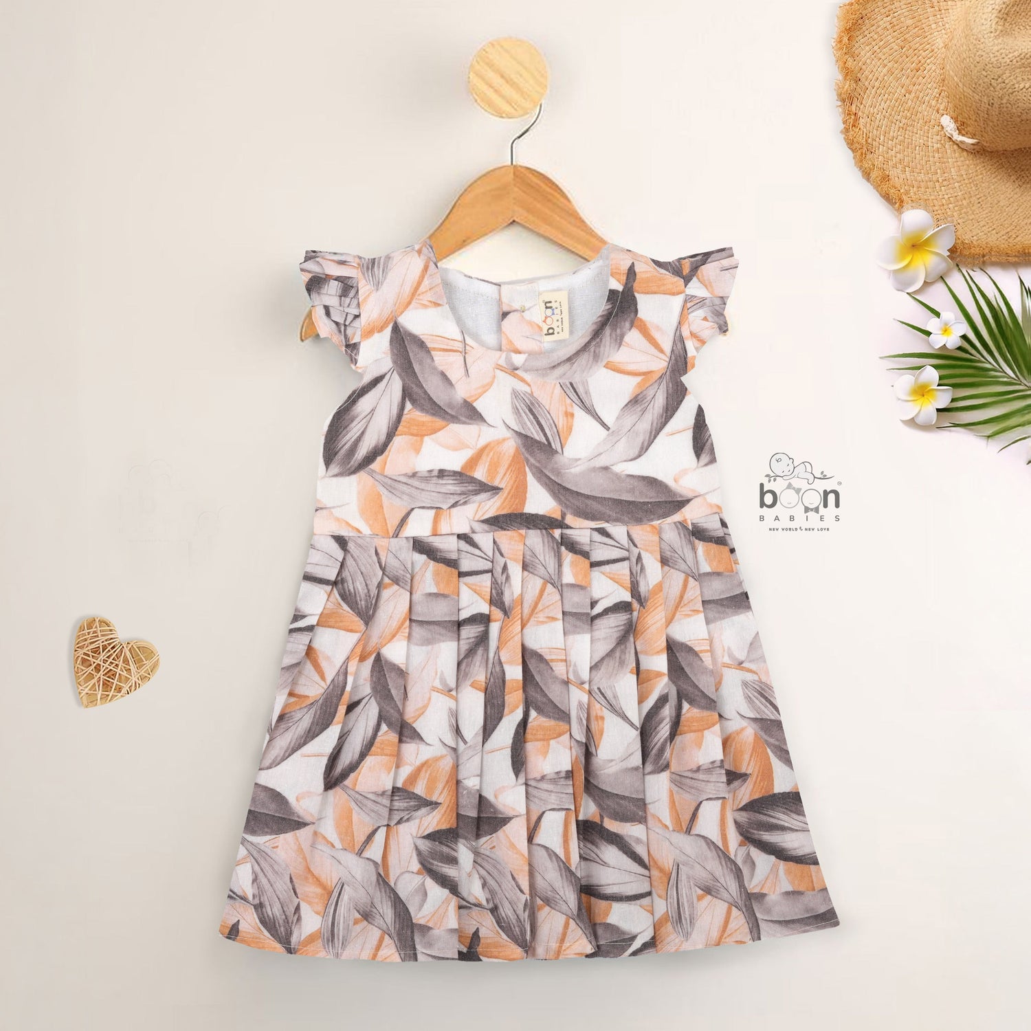 Elegant cotton frock with peach & grey leaf print and cap sleeves. Ideal for girls aged 6M to 5Y.