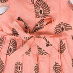Peach cotton frock with bold leaf print and flutter sleeves. Made for girls aged 6 months to 5 years. Soft, breathable, and perfect for summer wear.

