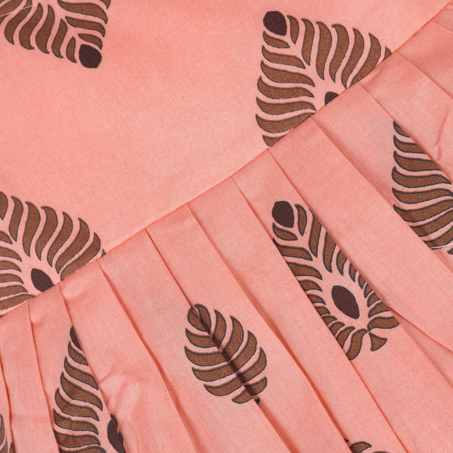 Peach cotton frock with bold leaf print and flutter sleeves. Made for girls aged 6 months to 5 years. Soft, breathable, and perfect for summer wear.
