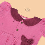 Pink Side Pleated Frock maroon collar & bow detailing. Sizes 6M–4Y. Perfect blend of comfort & festive charm for baby girls.