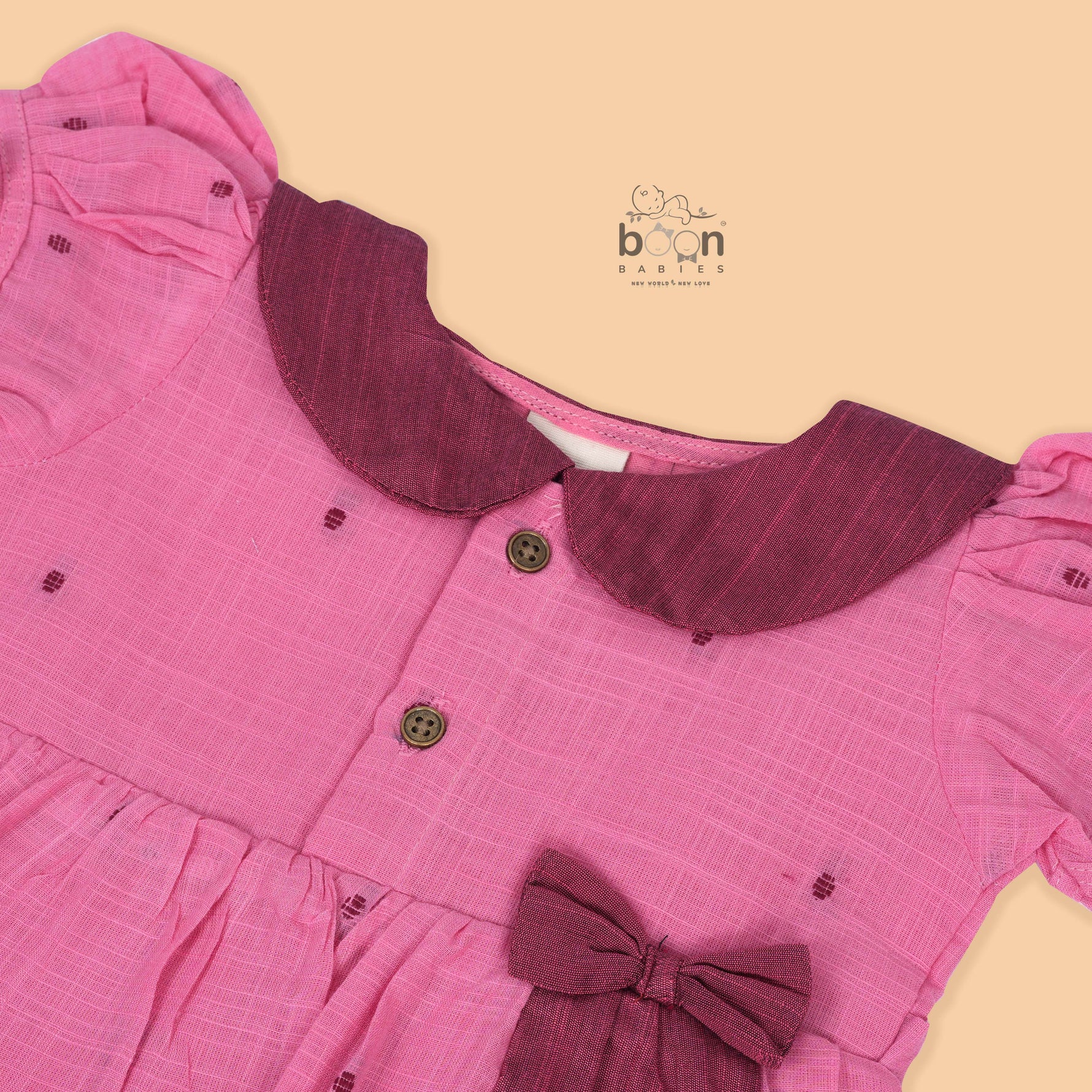 Pink Side Pleated Frock maroon collar & bow detailing. Sizes 6M–4Y. Perfect blend of comfort & festive charm for baby girls.
