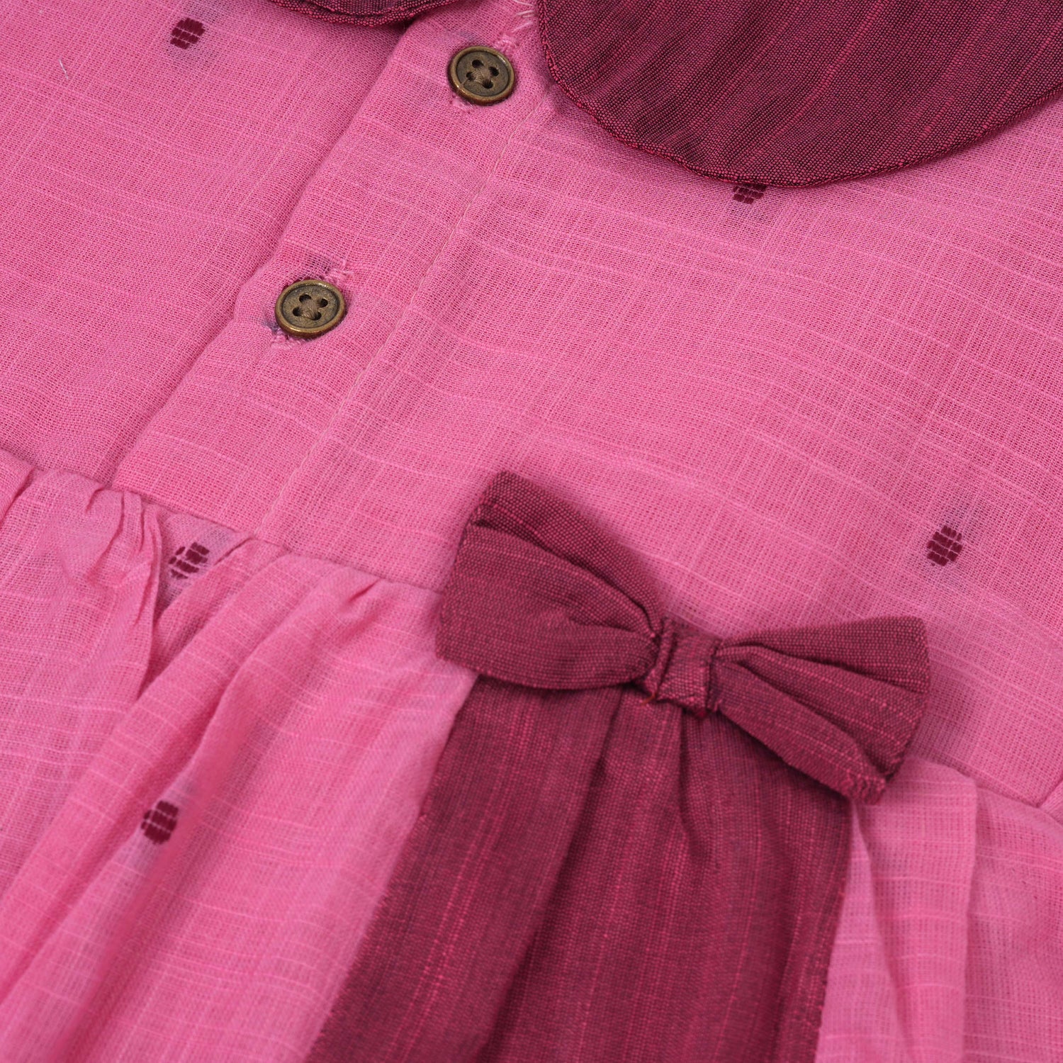 Pink Side Pleated Frock maroon collar & bow detailing. Sizes 6M–4Y. Perfect blend of comfort & festive charm for baby girls.