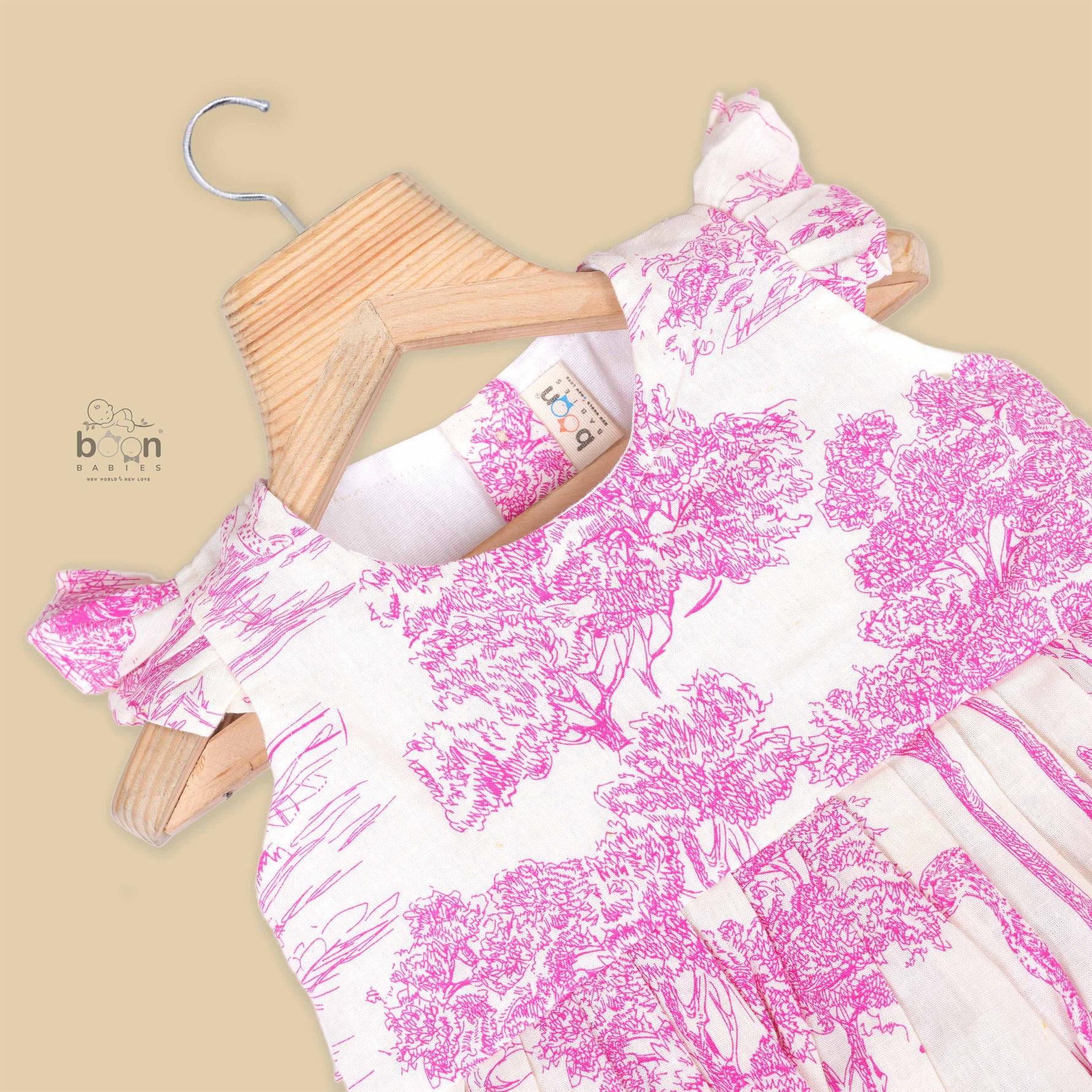 Pink wildlife print cotton frock with flutter sleeves for girls aged 6 months to 5 years. Breathable, soft and playful design from Boon Babies.

