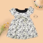 Black & white cotton Side Pleated Frock with floral print, contrast collar & bow detail. Stylish & comfy for baby girls aged 6M–4Y.