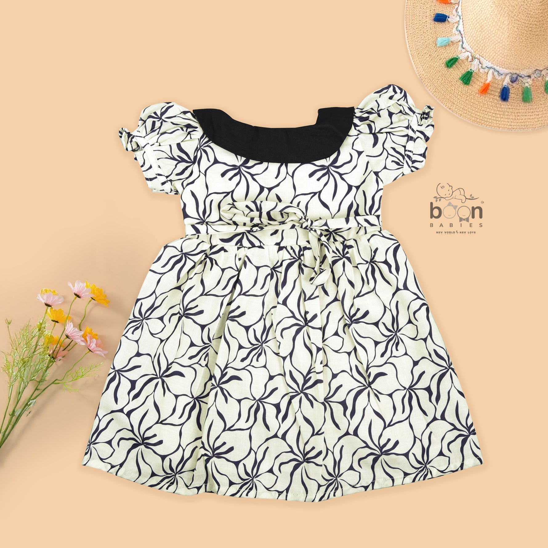 Black & white cotton Side Pleated Frock with floral print, contrast collar & bow detail. Stylish & comfy for baby girls aged 6M–4Y.