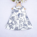 Toddler girl wearing a white and blue sleeveless cotton frock with forest and elephant print – soft summer wear from Boon Babies, Coimbatore.