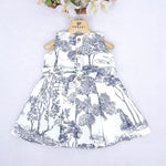 Toddler girl wearing a white and blue sleeveless cotton frock with forest and elephant print – soft summer wear from Boon Babies, Coimbatore.