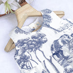 Toddler girl wearing a white and blue sleeveless cotton frock with forest and elephant print – soft summer wear from Boon Babies, Coimbatore.