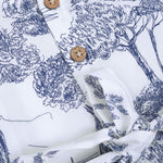 Toddler girl wearing a white and blue sleeveless cotton frock with forest and elephant print – soft summer wear from Boon Babies, Coimbatore.