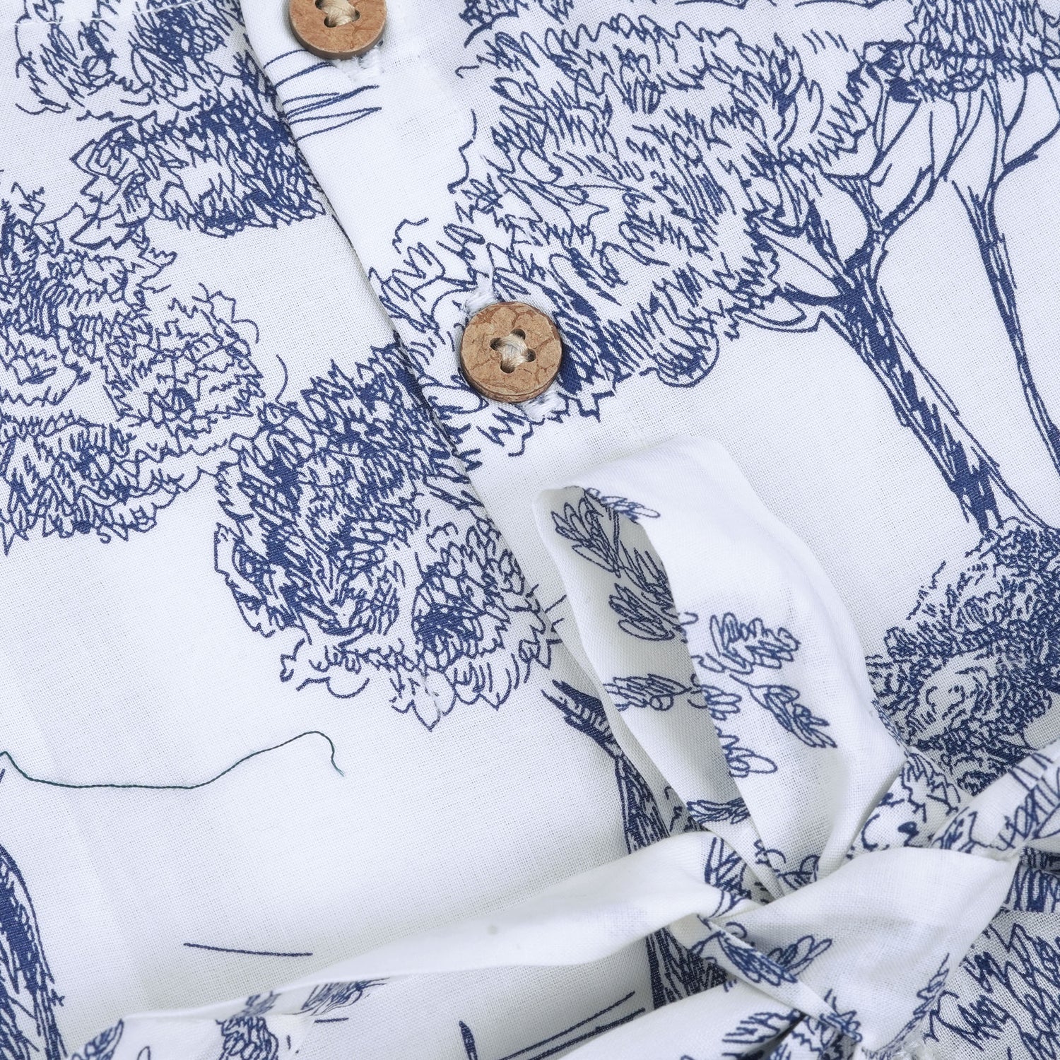 Toddler girl wearing a white and blue sleeveless cotton frock with forest and elephant print – soft summer wear from Boon Babies, Coimbatore.
