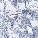 Toddler girl wearing a white and blue sleeveless cotton frock with forest and elephant print – soft summer wear from Boon Babies, Coimbatore.