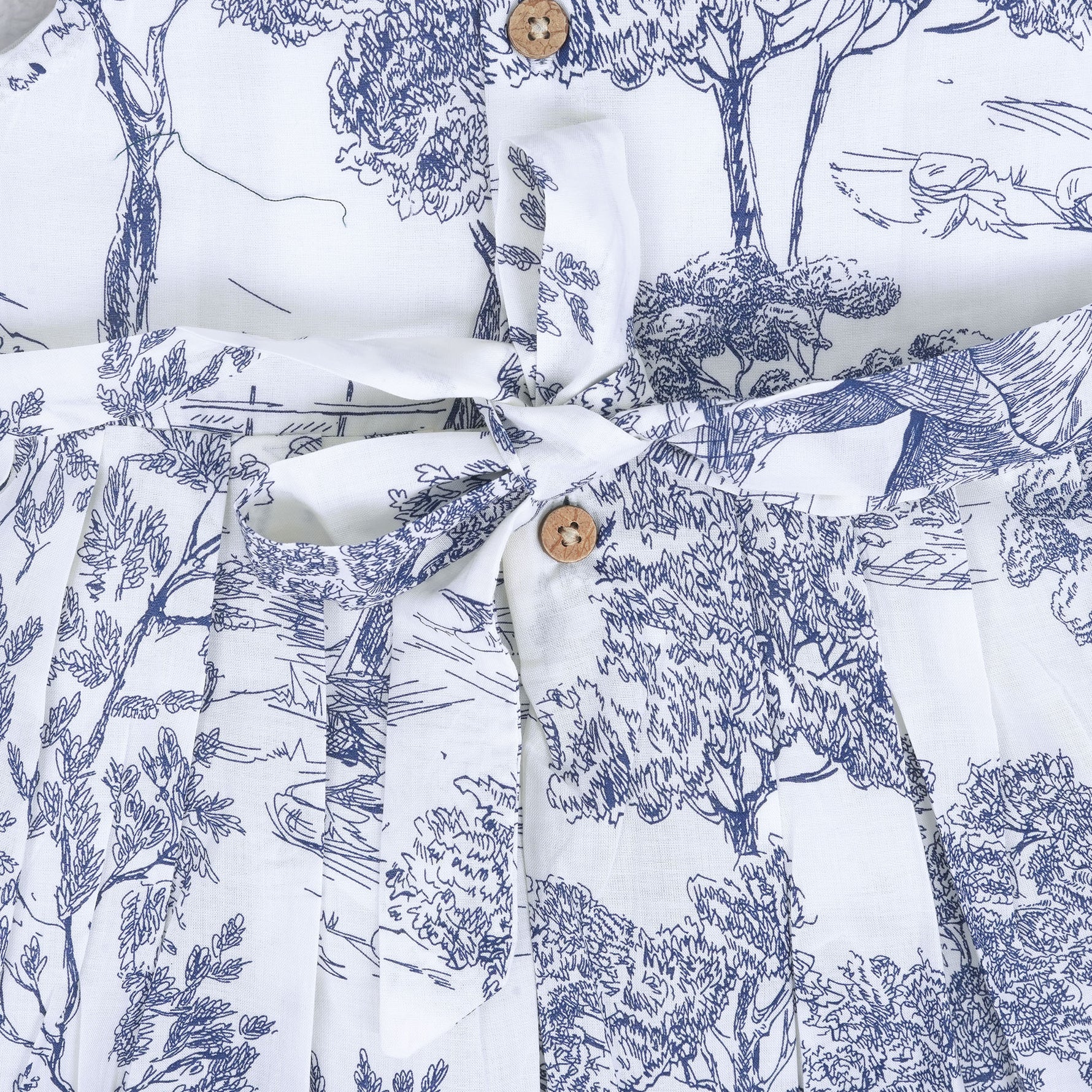 Toddler girl wearing a white and blue sleeveless cotton frock with forest and elephant print – soft summer wear from Boon Babies, Coimbatore.