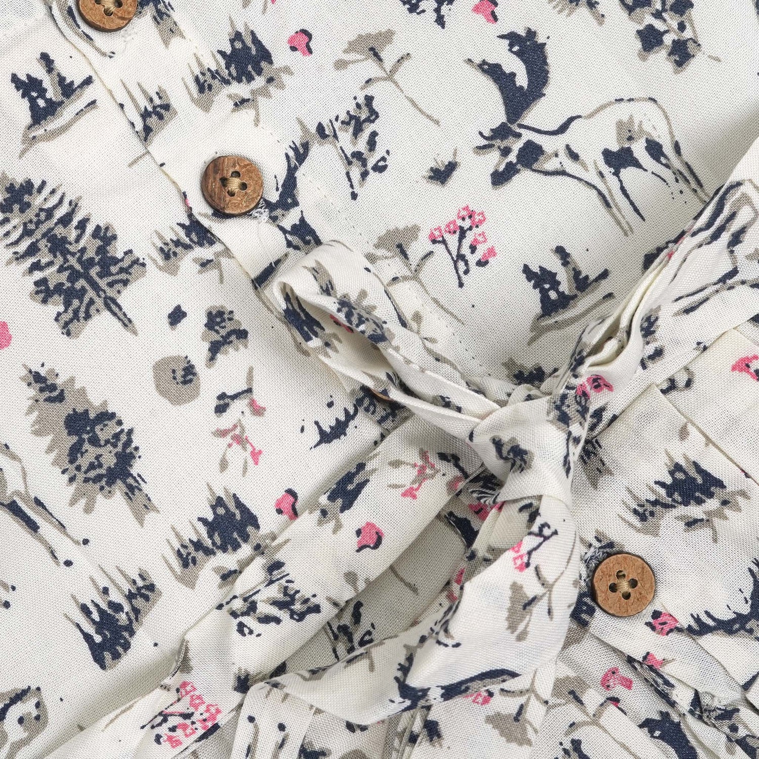 Toddler girl wearing a sleeveless white cotton frock with pink and green floral print – lightweight summer dress from Boon Babies, Coimbatore.