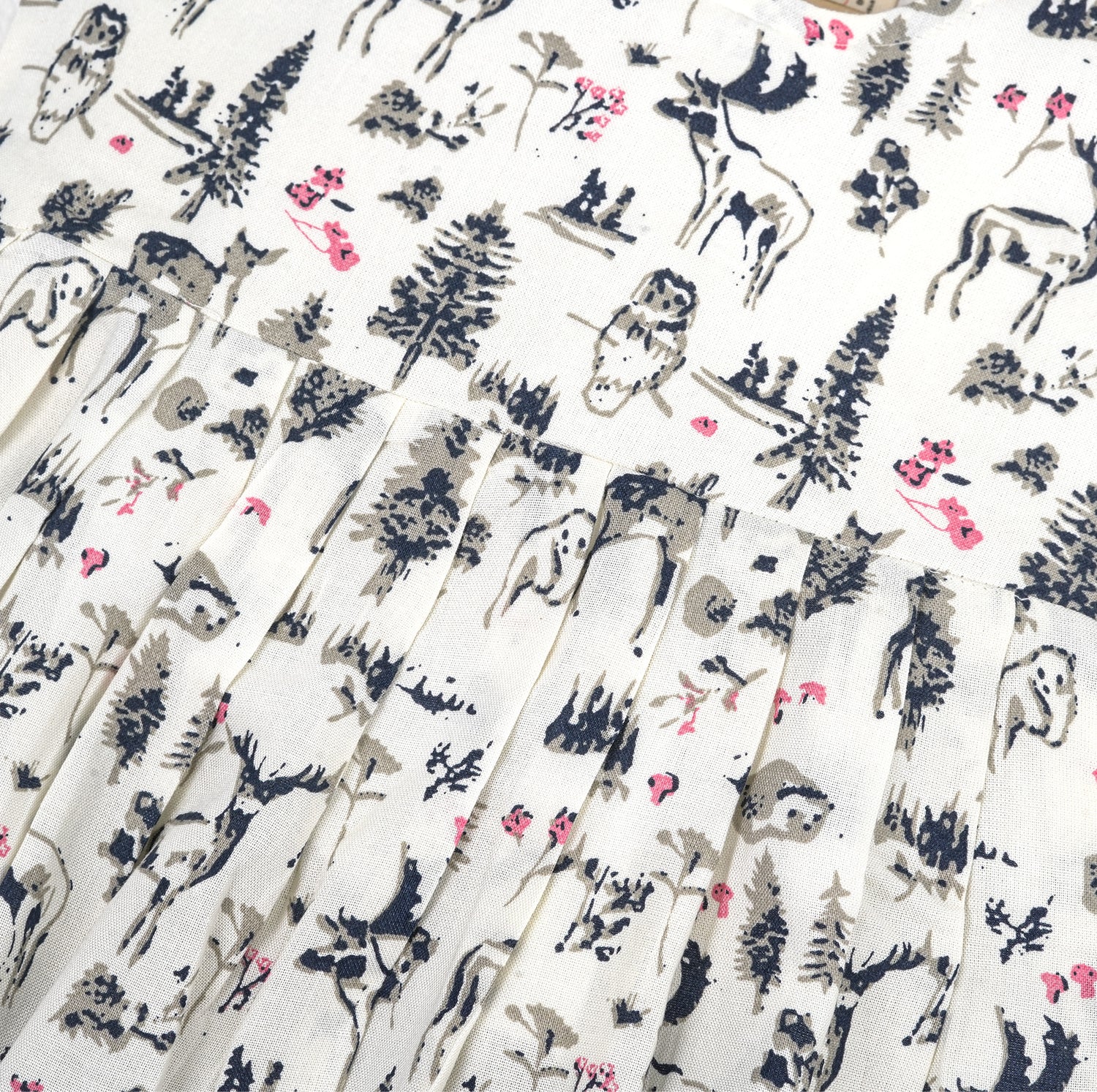 Toddler girl wearing a sleeveless white cotton frock with pink and green floral print – lightweight summer dress from Boon Babies, Coimbatore.