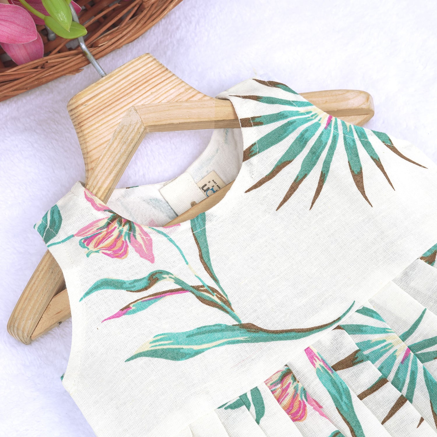 Toddler girl in a white sleeveless frock with navy blue and pink forest animal print – pure cotton summer dress from Boon Babies, Coimbatore.