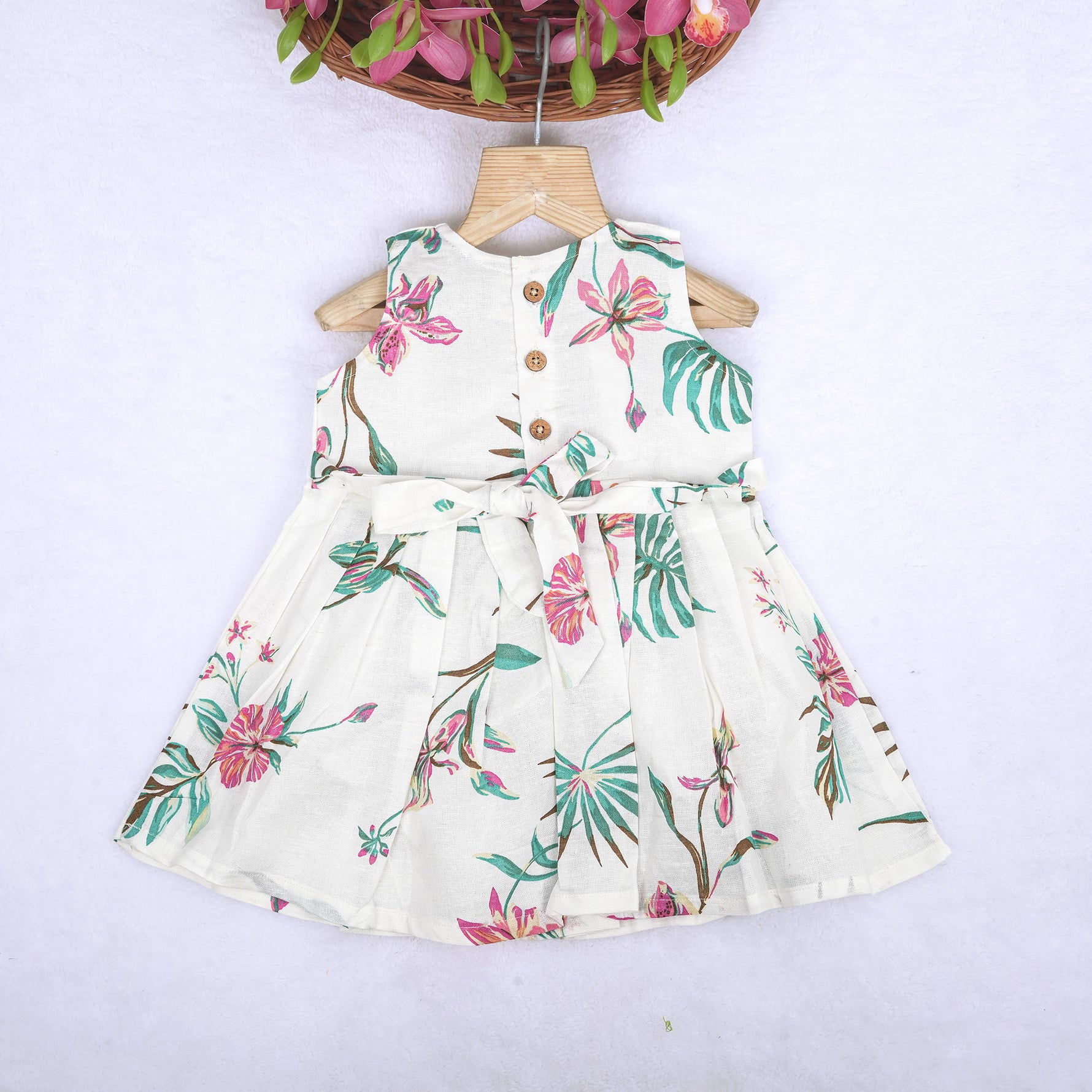 Toddler girl in a white sleeveless frock with navy blue and pink forest animal print – pure cotton summer dress from Boon Babies, Coimbatore.