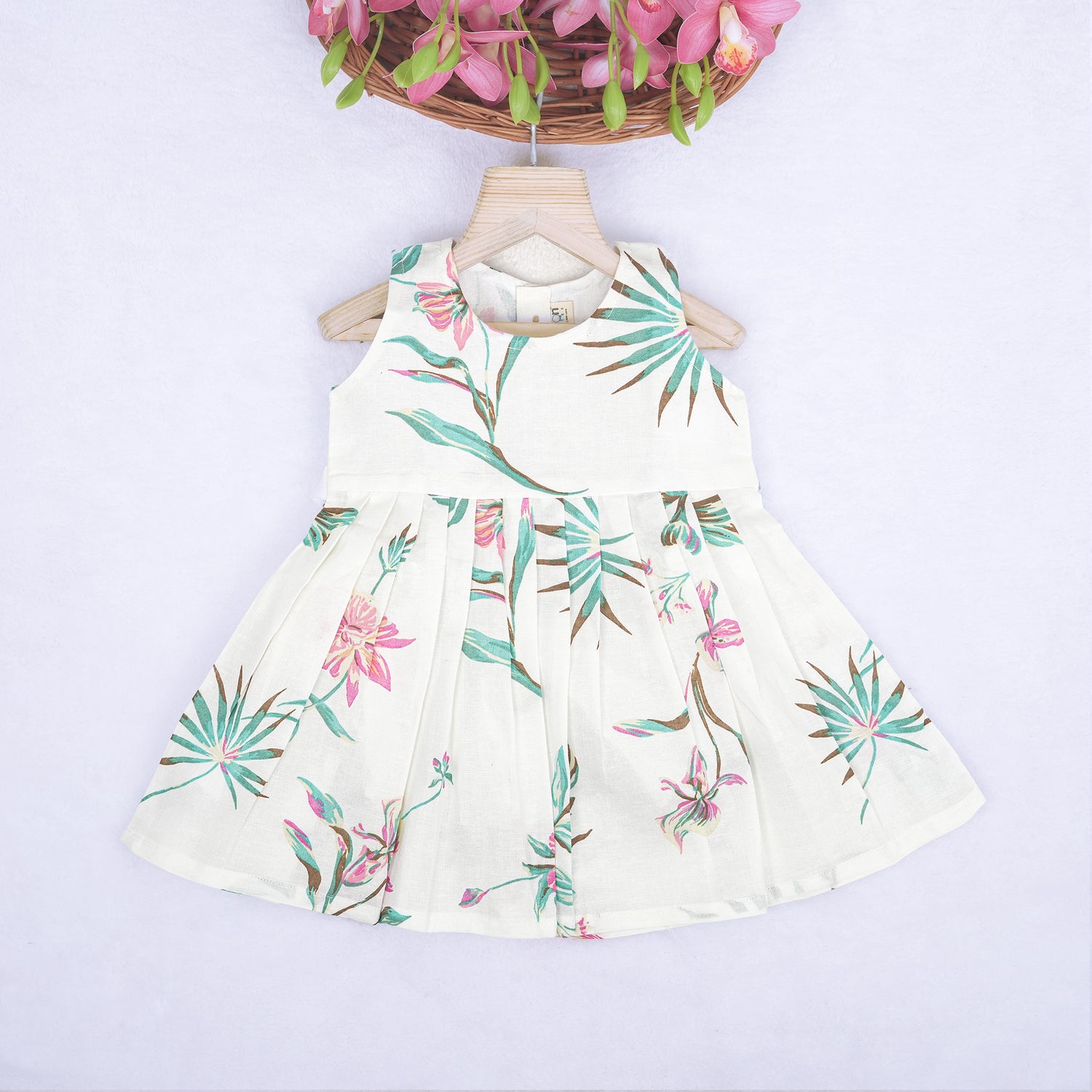 Toddler girl in a white sleeveless frock with navy blue and pink forest animal print – pure cotton summer dress from Boon Babies, Coimbatore.