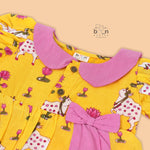 Yellow cotton puff frock with pink collar, bow tie & lotus print. Cute & comfy for girls aged 6M–4Y.