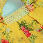 Cheerful yellow floral frock in soft linen with frill sleeves. Ages 6 months to 4 years. Summer-perfect wear for baby girls.
