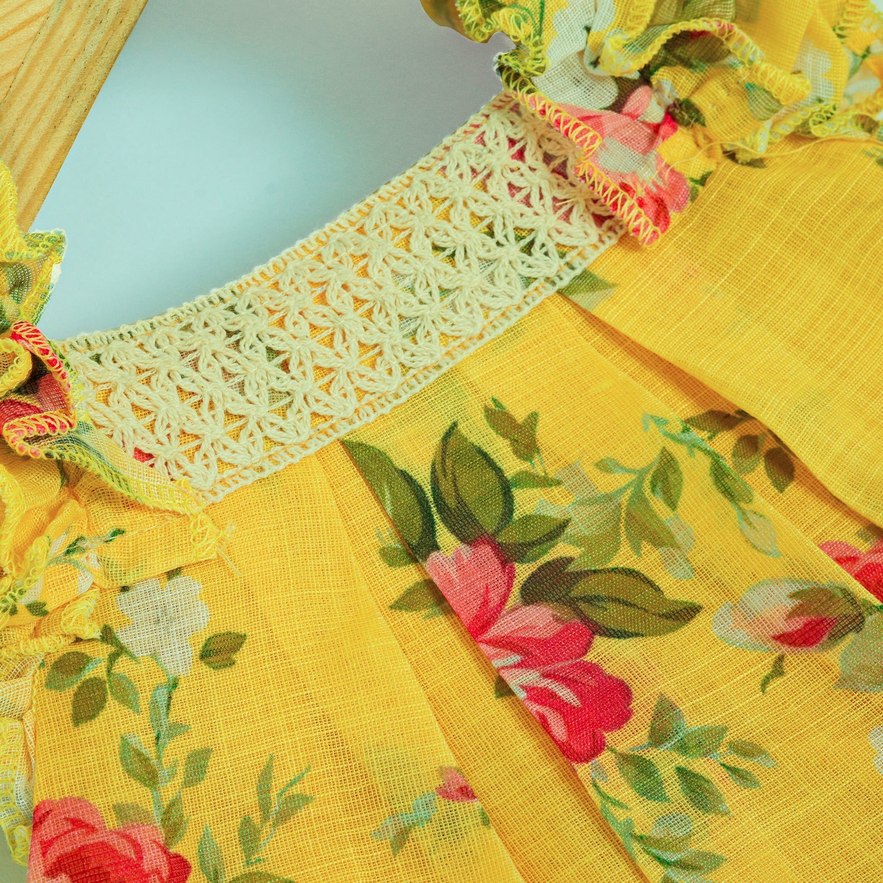 Cheerful yellow floral frock in soft linen with frill sleeves. Ages 6 months to 4 years. Summer-perfect wear for baby girls.
