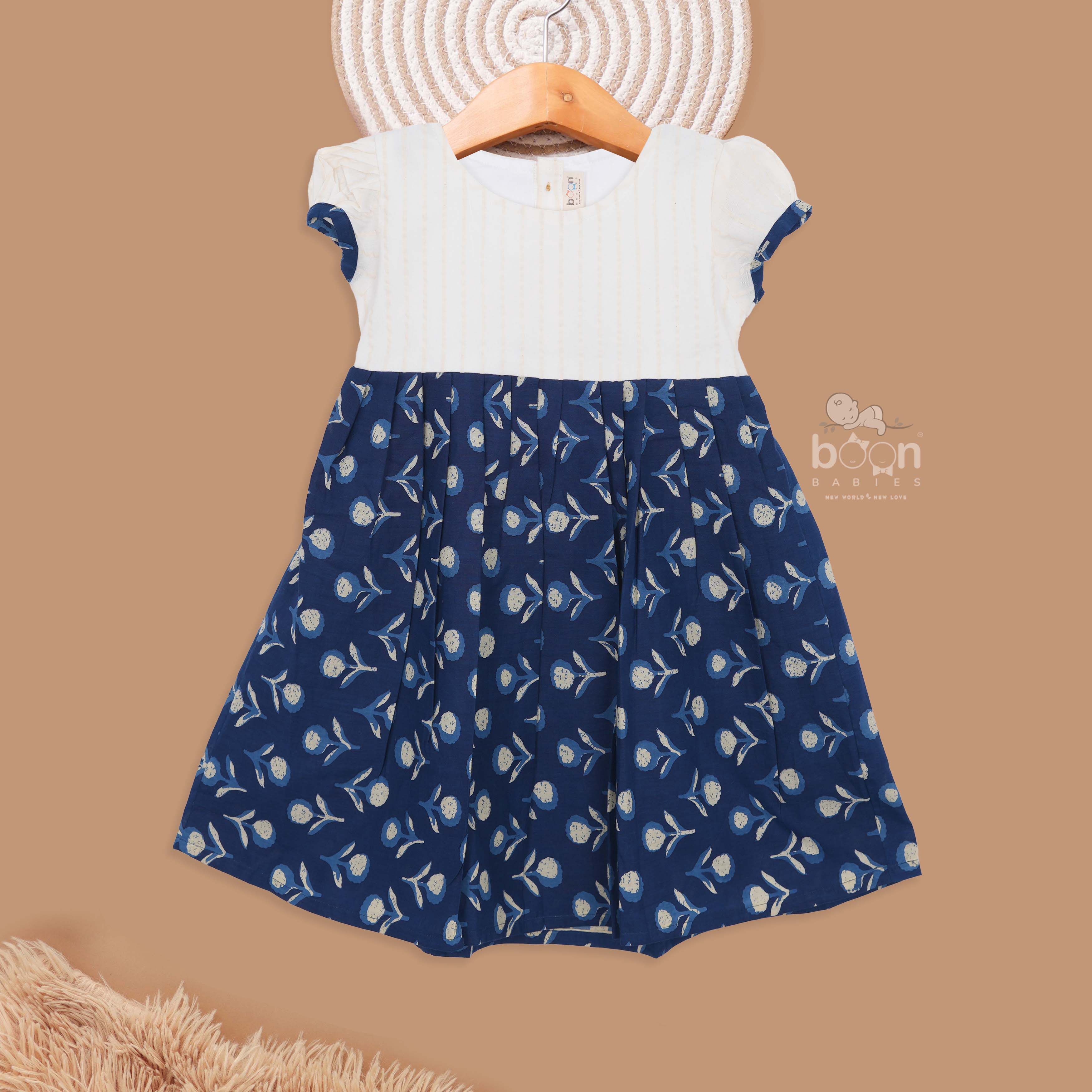 Girls printed cotton frock by Boon Babies featuring floral patterns, designed for kids aged 6 to 12 years, in blue.