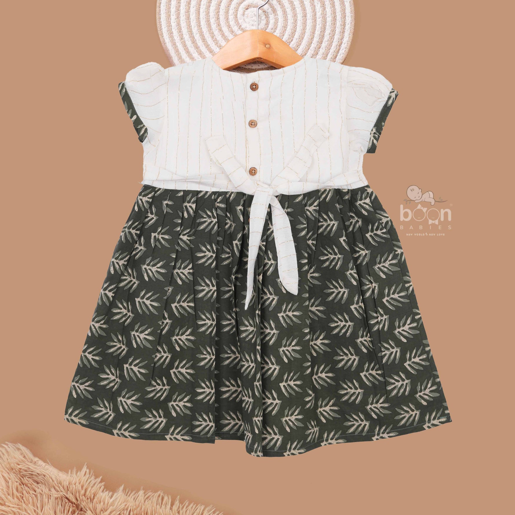 Girls printed leaf frock in olive green cotton for kids, featuring charming design by Boon Babies for ages 6 to 12 years.