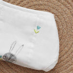 White muslin baby nappy with bunny print. For 0–3 months. Soft, reusable, and skin-friendly with easy tie closure.