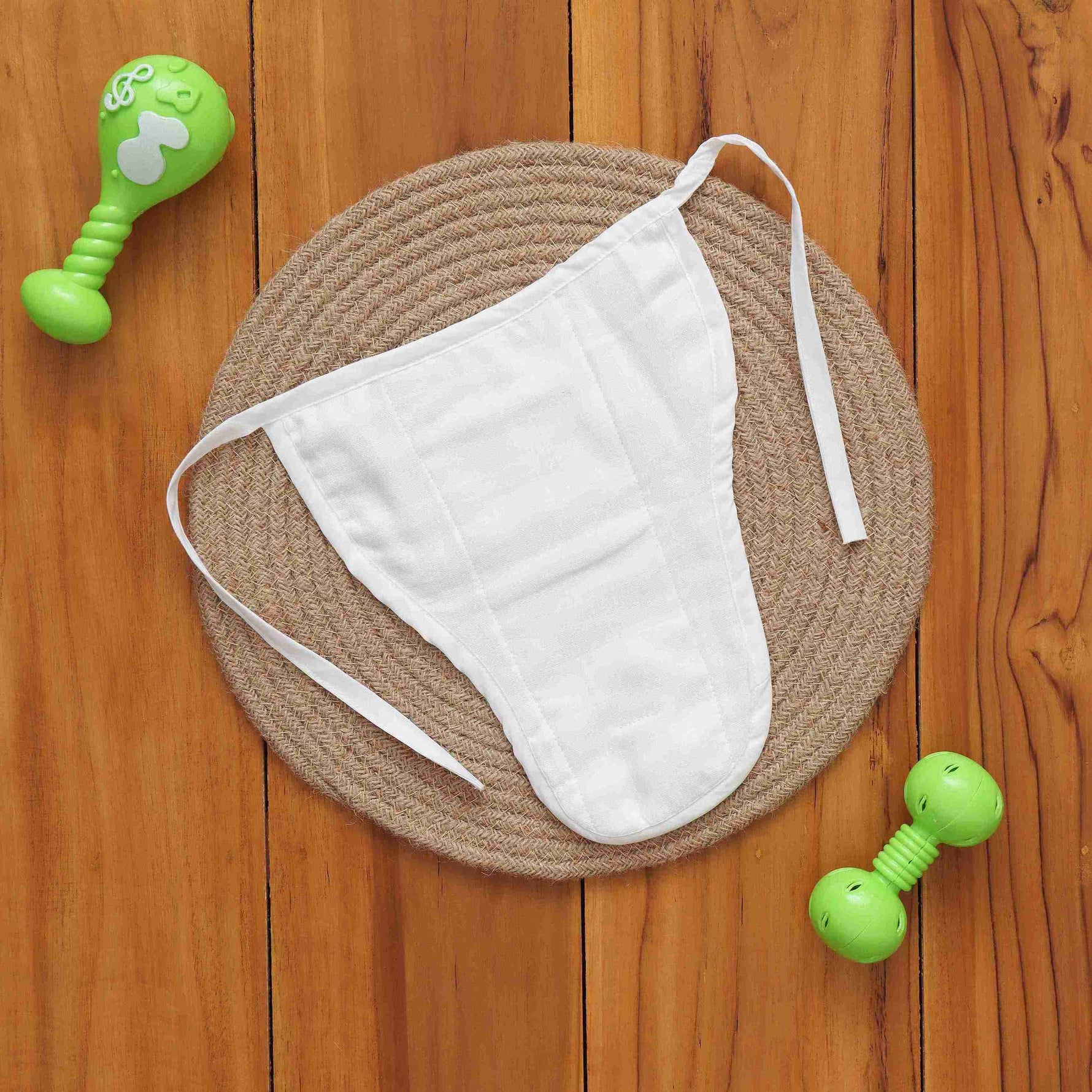 Soft muslin nappy with red & green leaf print. 0–3 months. Lightweight, reusable, and baby-friendly with tie closure.
