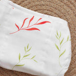 Soft muslin nappy with red & green leaf print. 0–3 months. Lightweight, reusable, and baby-friendly with tie closure.

