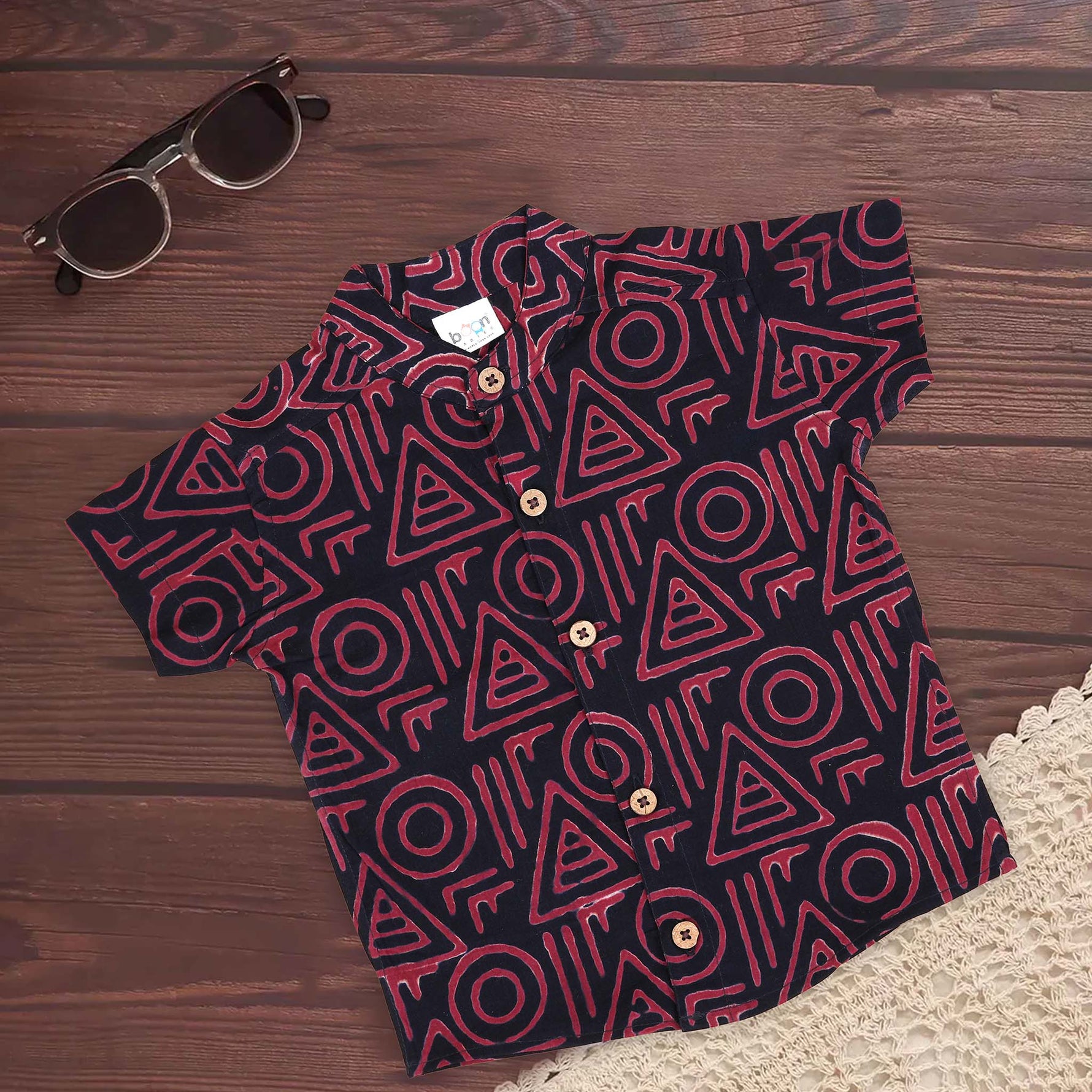 Red tribal printed cotton shirt with Chinese collar for babies by Boon Babies, featuring bright, colorful tribal print design.
