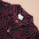 Red tribal printed cotton shirt with Chinese collar for babies by Boon Babies, featuring vibrant tribal design.