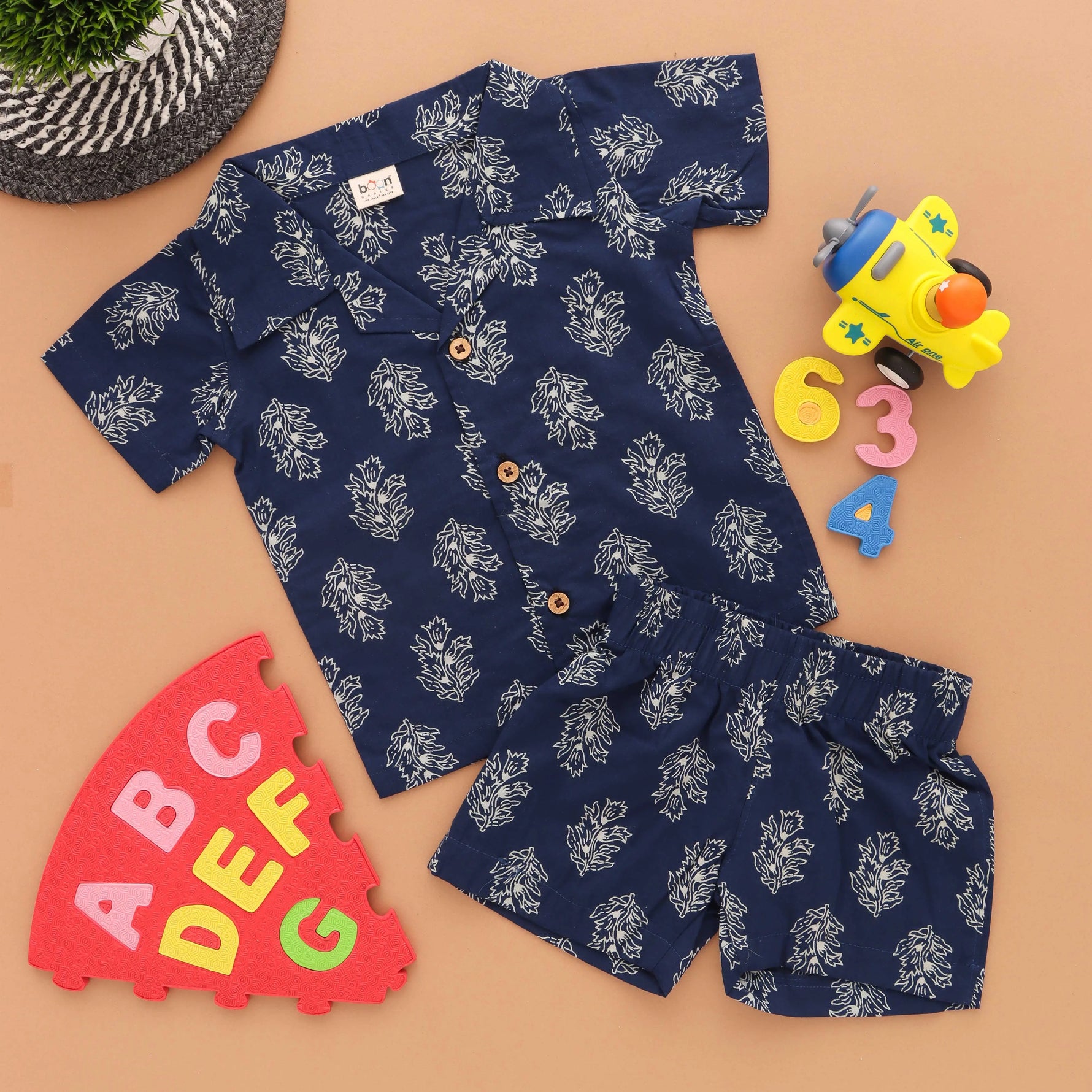 Navy blue floral print boys' shirt and shorts set with open collar by Boon Babies, made from Jaipur cotton for ages 6-12 months.