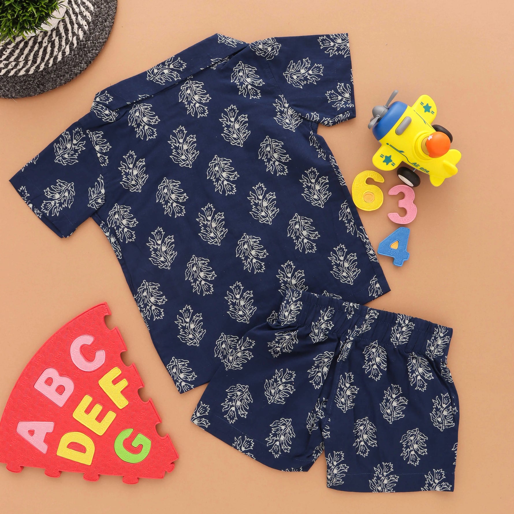 Navy blue floral printed boys' shirt and shorts set with open collar from Boon Babies, featuring colorful flower prints for trendy kids.