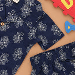 Trendy navy blue floral print boys' shirt and shorts set by Boon Babies with open collar, perfect for warm weather.