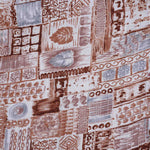 Boy wearing earthy brown tribal printed cotton shirt with straight collar, designed for boys by Boon Babies.