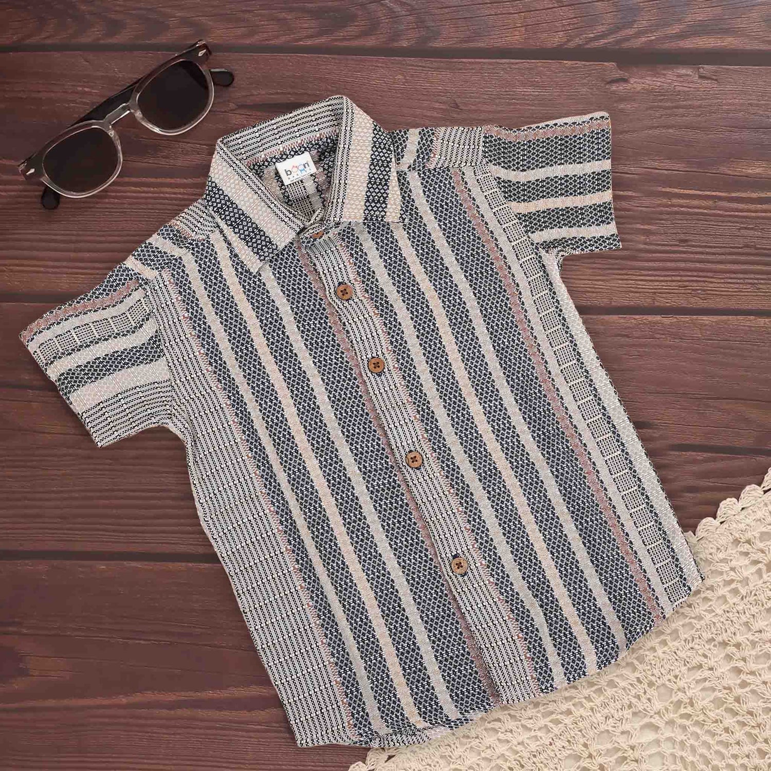 Red tribal-inspired print cotton boys' shirt with straight collar, made by Boon Babies, featuring vibrant tribal patterns for kids.