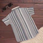 Boy wearing a red tribal-inspired printed cotton shirt with a straight collar from Boon Babies for ages 6-12 months.