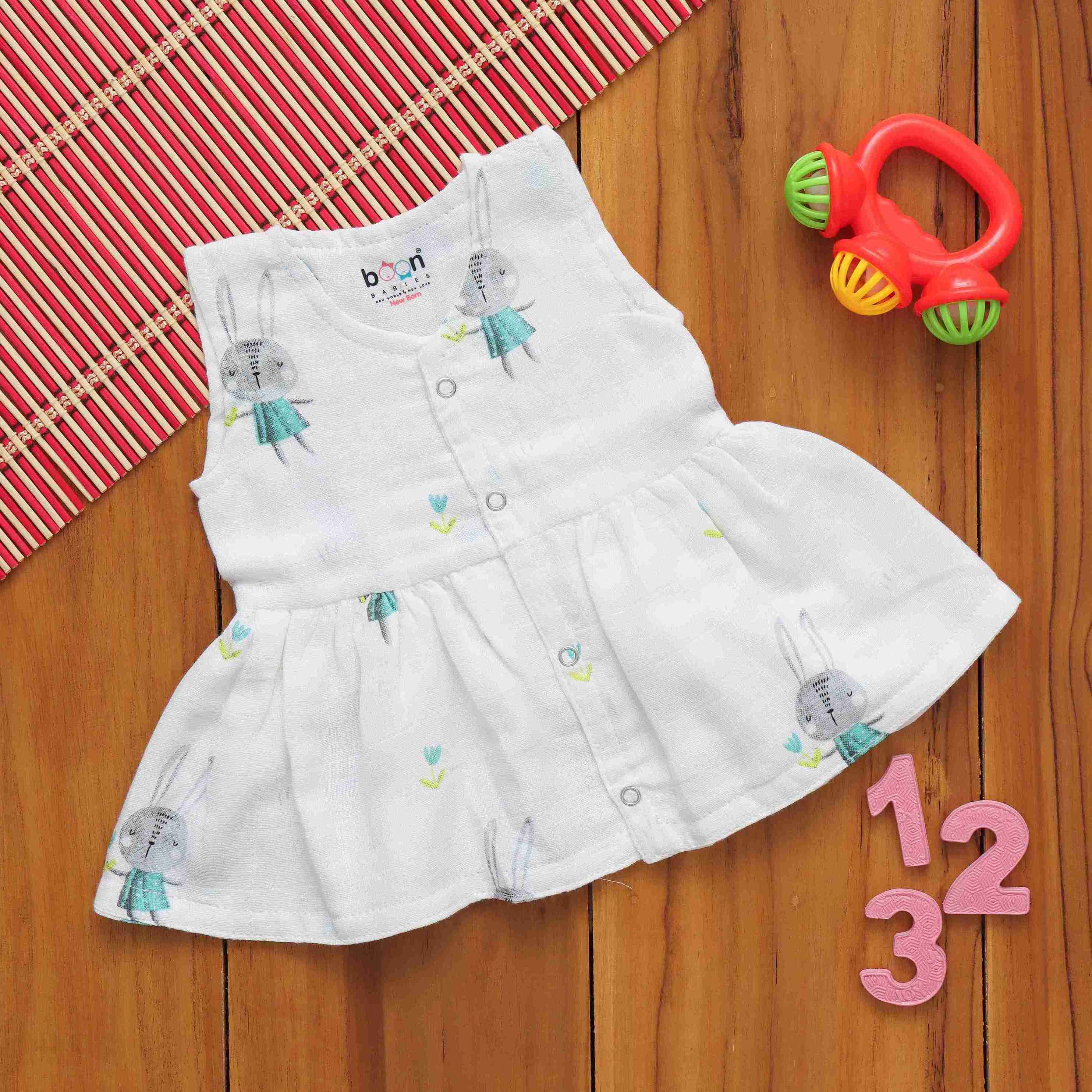 White sleeveless baby frock with adorable bunny print by Boon Babies, featuring a whimsical charm and soft muslin fabric.